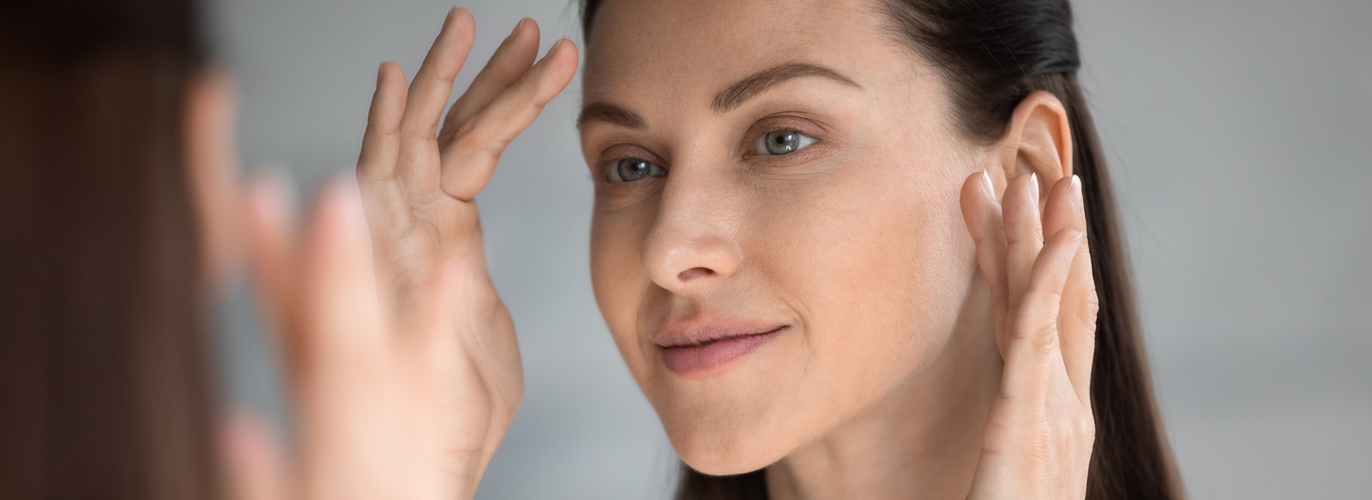 woman touches her hair